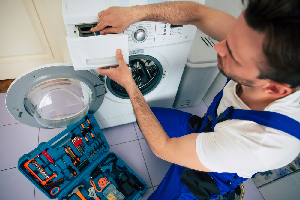 Technician fixing washing machine motor in Riyadh